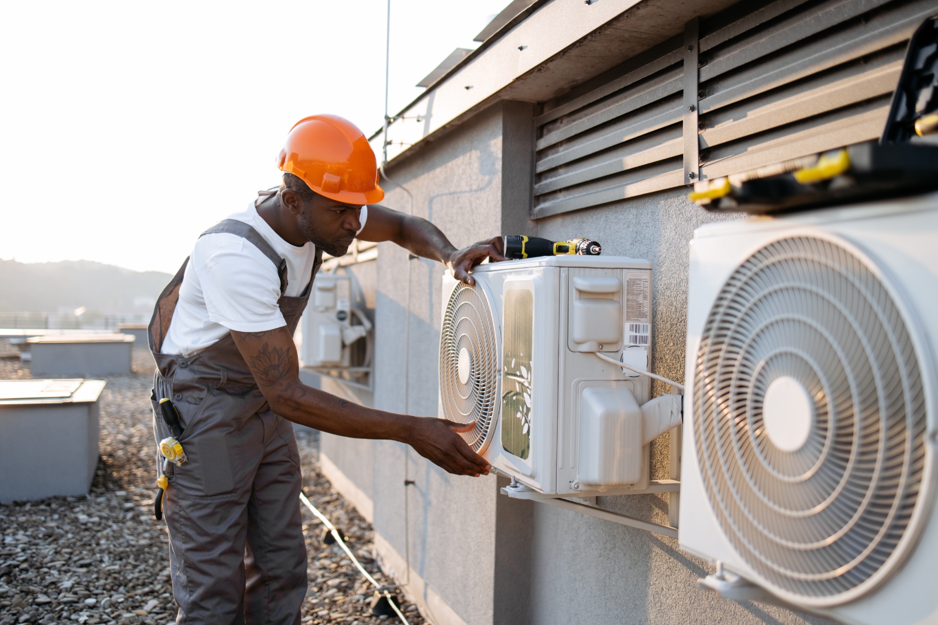 african-man-in-uniform-checking-air-conditioner-on-2024-12-12-03-25-24-utc 1