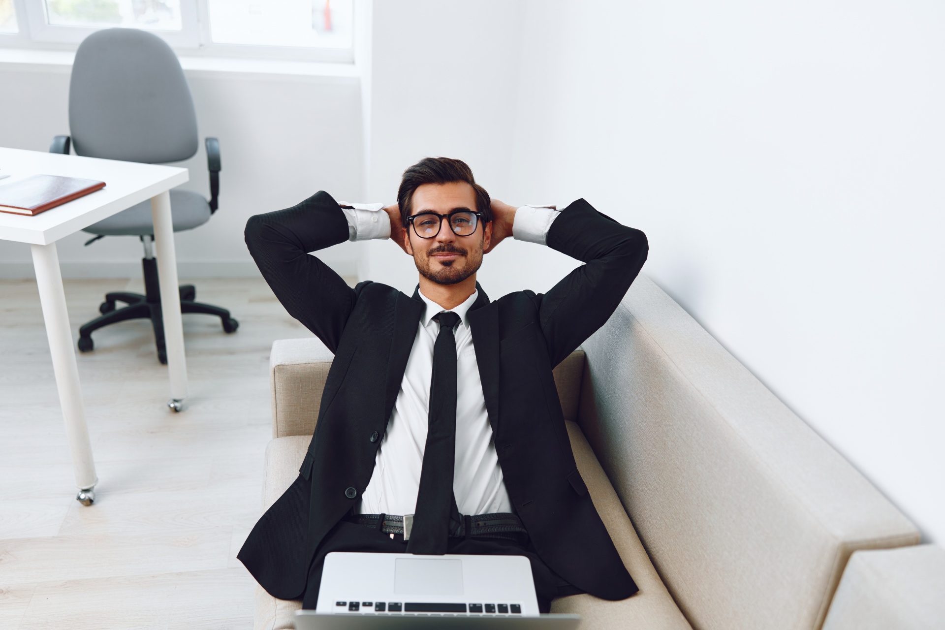 man-business-couch-home-call-video-smiling-laptop-2025-03-11-12-35-35-utc 1